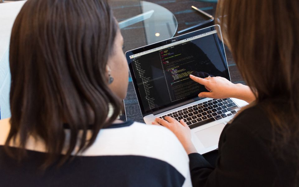 Tech Solution engineers reviewing code together